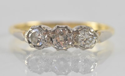 Lot 1302 - An 18ct yellow and white gold three stone...