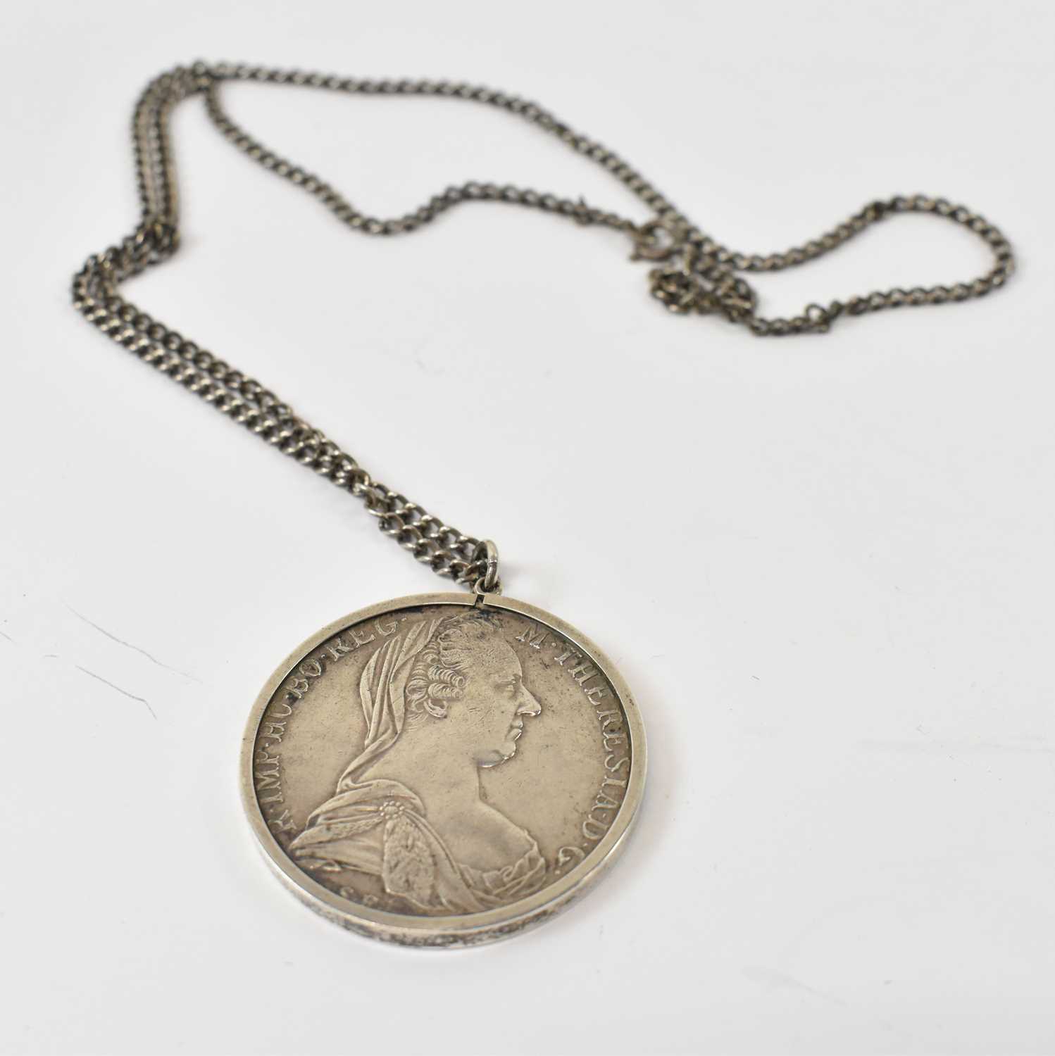 Lot 504 - A silver Austrian thaler mounted and suspended...