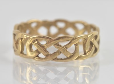 Lot 1231 - A 9ct yellow gold band ring with open Celtic...