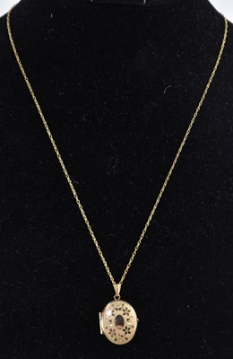 Lot 1285 - A 9ct yellow gold oval double locket, with...