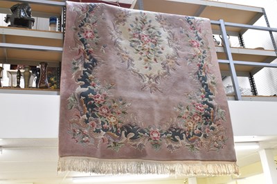 Lot 107 - A modern pink ground Chinese superwash carpet,...