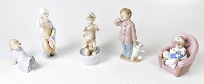 Lot 124 - LLADRO; a figure group of a young girl bathing,...