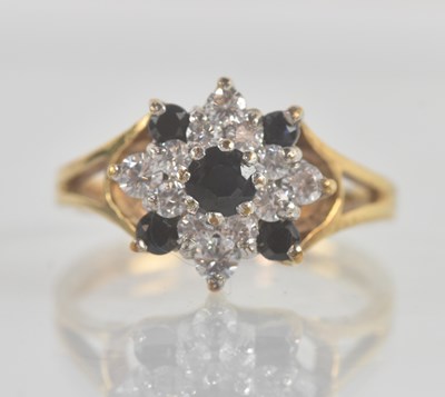 Lot 1239 - A 9ct yellow gold sapphire and white stone...