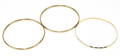 Lot 1278 - A pair of 9ct yellow gold bangles, internal...