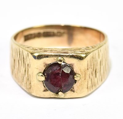 Lot 1210 - A 9ct yellow gold ring set with a garnet, size...