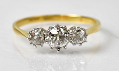Lot 1134 - An 18ct yellow gold and platinum three-stone...