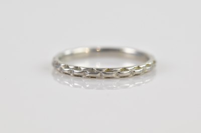 Lot 2584 - A platinum wedding band with textured detail...