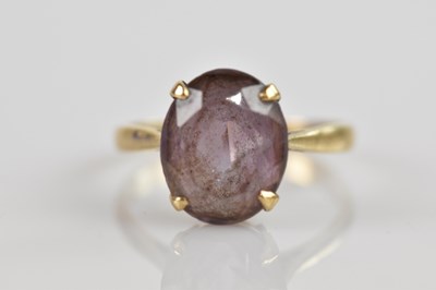 Lot 2594 - A yellow metal dress ring set with an amethyst...