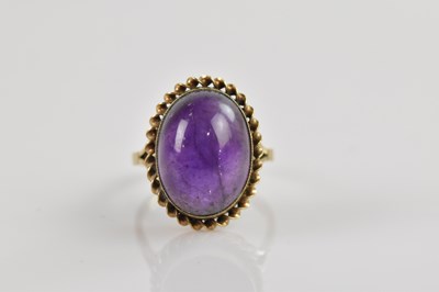 Lot 2339 - A 9ct yellow gold amethyst cabochon set dress...