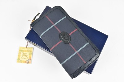 Lot 109 - BURBERRYS; a navy blue coated leather check...