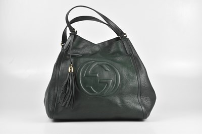 Lot 158 - GUCCI; a large dark green embossed leather...