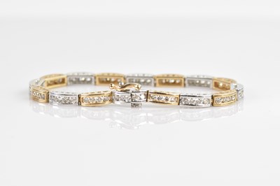 Lot 1125 - A 9ct yellow and white gold tennis bracelet,...