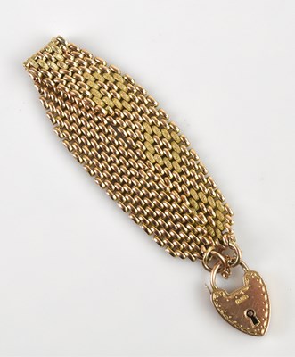 Lot 1123 - A yellow textured metal gate link bracelet...