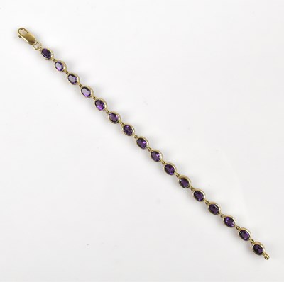 Lot 1227 - A yellow metal tennis bracelet, stamped '375',...