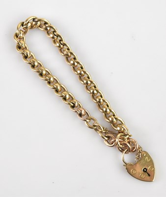 Lot 1150 - A 9ct yellow gold curb link bracelet, with...