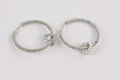 Lot 1403 - A pair of white metal hoop earrings, stamped...