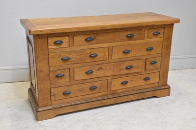 Lot 131 - A reproduction oak chest of ten drawers, with...