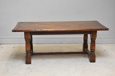 Lot 212 - A reproduction oak refectory table, on block...