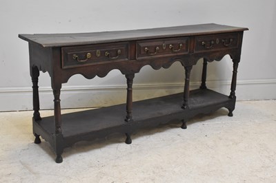 Lot 60 - A George III oak dresser base, with three...