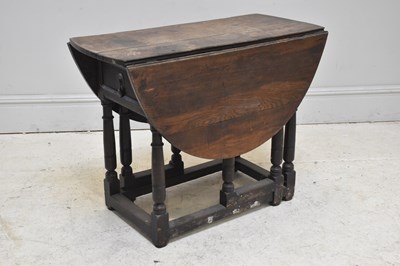 Lot 94 - An 18th century oak drop-leaf gateleg dining...