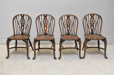 Lot 299 - Four 20th century elm seated wheelback dining...