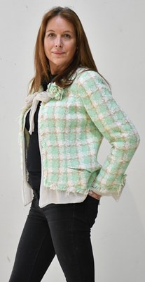 Lot 213 - CHANEL; a green and cream bouclé short jacket,...