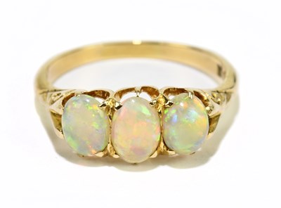 Lot 1148 - A 15ct yellow gold and three stone opal ring,...