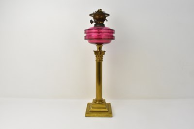 Lot 83 - A 19th century oil lamp with red glass font,...