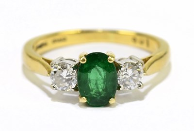 Lot 1025 - An 18ct yellow gold emerald and diamond ring,...