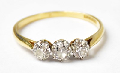 Lot 1136 - An 18ct yellow gold ring set with three...