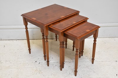 Lot 156 - A reproduction yew wood nest of  three tables,...