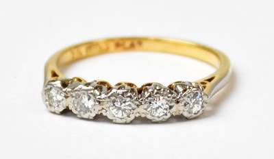 Lot 1137 - An 18ct yellow gold ring set with five...