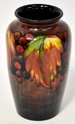 Lot 147 - MOORCROFT; a 'Grape and Vine' pattern vase of...