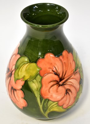 Lot 148 - MOORCROFT; a 'Hibiscus' pattern vase of ovoid...
