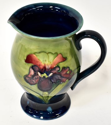 Lot 150 - MOORCROFT; an 'Iris' pattern jug of blue and...