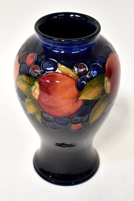 Lot 153 - MOORCROFT; a 'Pomegranate' baluster form vase...