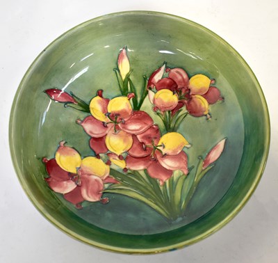 Lot 146 - MOORCROFT; a 'Freesia' pattern bowl of green...