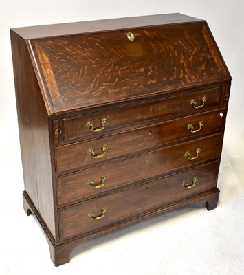 Lot 46 - A George III oak bureau, with lift-up top...