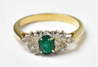 Lot 1175 - A yellow metal ring set with a central oval...