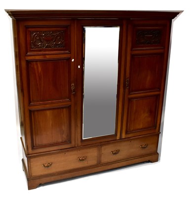 Lot 12 - An Edwardian walnut triple wardrobe, the...