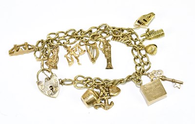 Lot 1261 - A 9ct yellow gold charm bracelet suspending a...