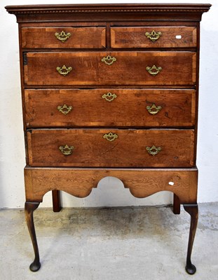 Lot 48 - A George III oak chest on stand, the dentil...