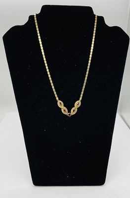 Lot 577 - An 18ct yellow gold ruby and diamond necklace...