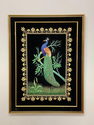 Lot 376 - An embroidered textile depicting a peacock...