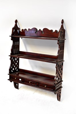 Lot 40 - A reproduction mahogany wall shelf with...