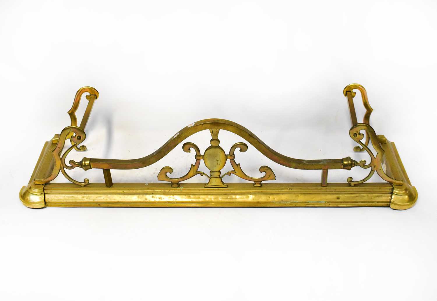 Lot 193 - A 19th century brass fire fender with arched