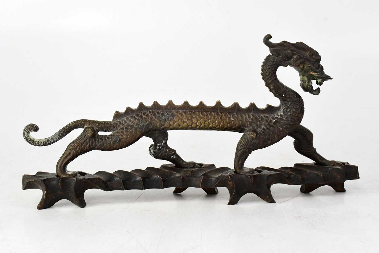 Lot 334 - A bronze model of a standing dragon, on a...