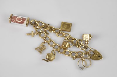 Lot 1115 - A 9ct gold flat link charm bracelet with 9ct...