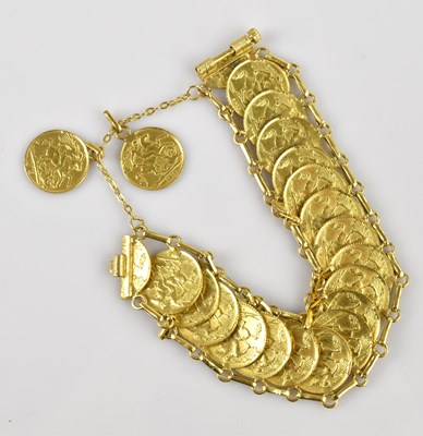 Lot 1090 - A yellow metal twenty-one coin set bracelet,...