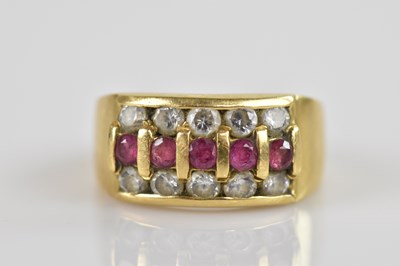 Lot 2307 - A yellow metal dress ring, set with clear and...